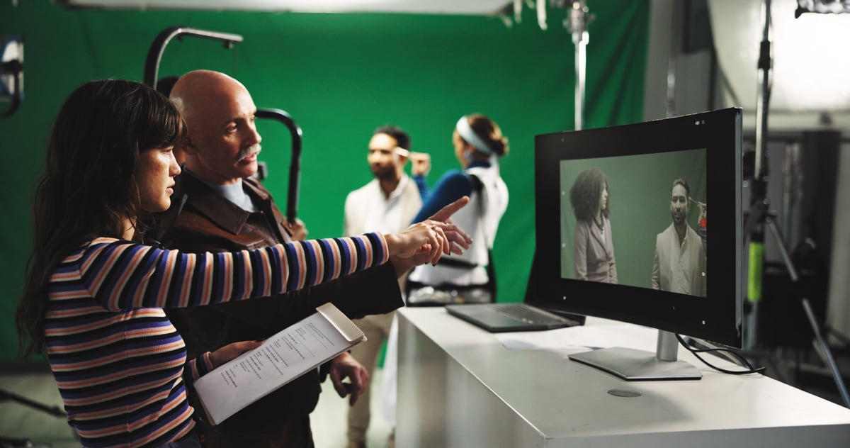 Director and producer with green screen for scene playback